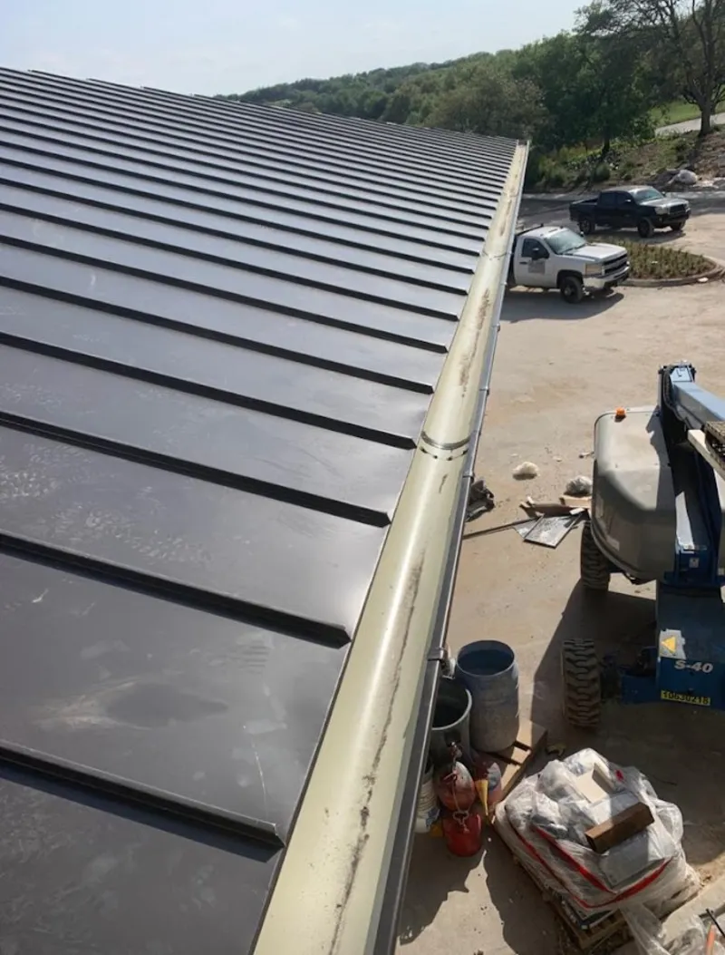 Standing seam panel and gutter detail on a metal roofing jobsite in South Milwaukee